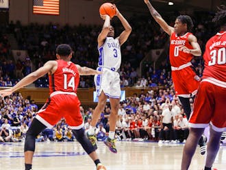 Jeremy Roach (team-high 20 points) shoots over Terquavion Smith in Duke's Tuesday win against N.C. State.