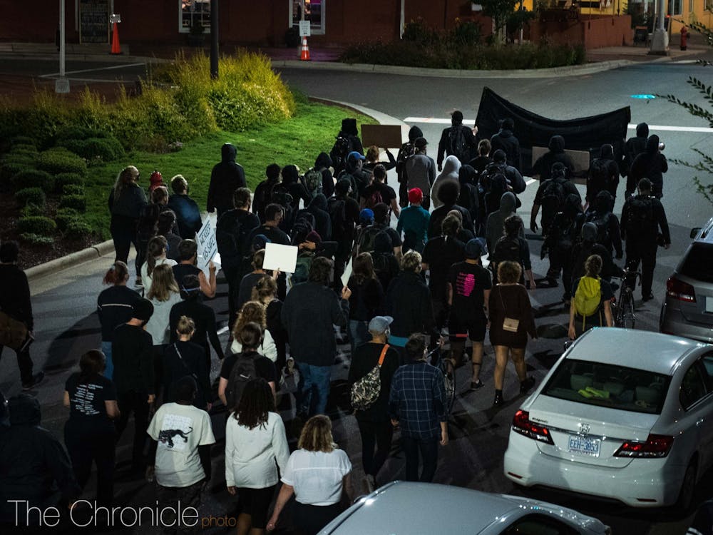 Protesters marching by Durham City Hall on Wednesday night. 