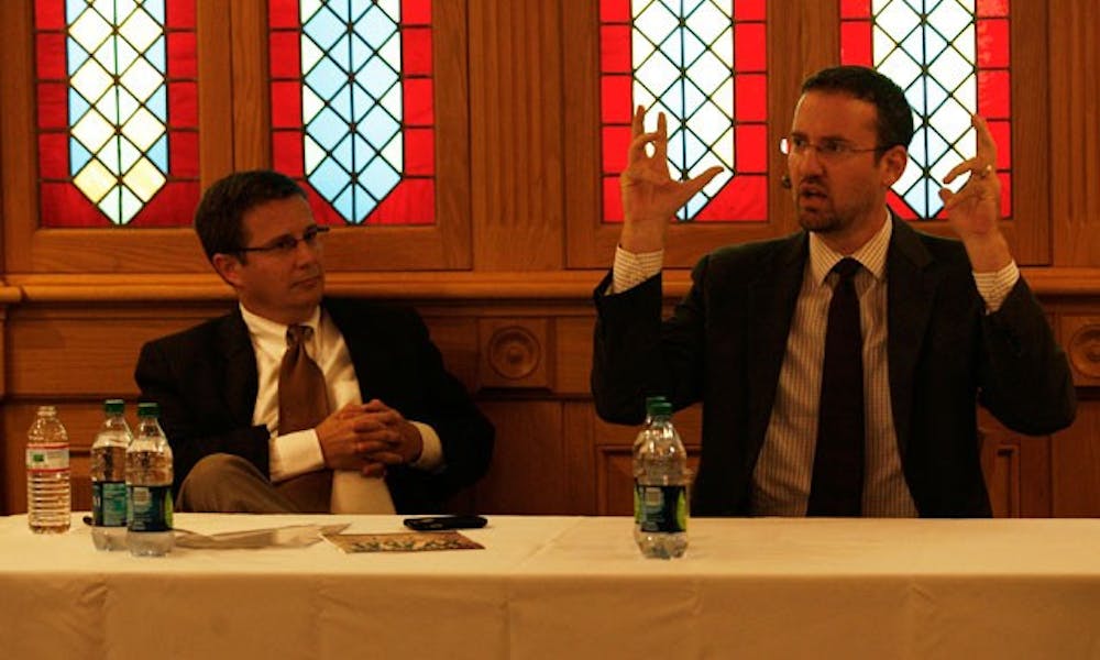 Moderator Peter Feaver and Will McCants, research analyst at the Center for Strategic Studies at CNA Analysis and Solutions, take part in a debate discussing the War on Terror in the Old Trinity Room Monday.