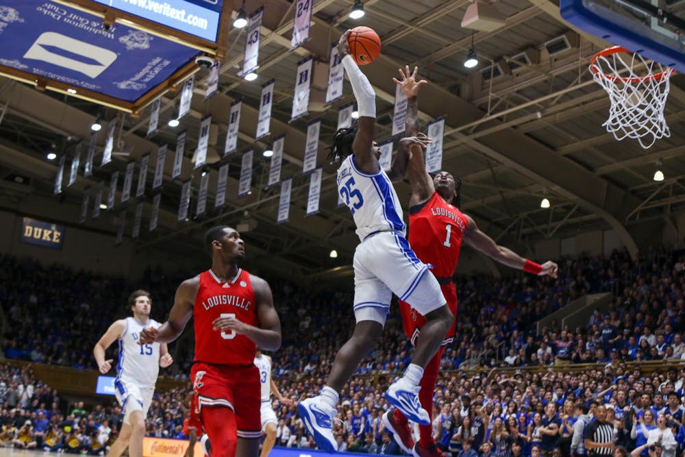 <p>Mark Mitchell skies for the dunk during Duke's Feb. 20 win against Louisville at Cameron Indoor Stadium.</p>