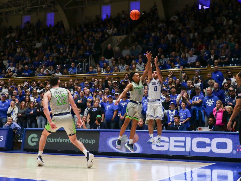 Jared McCain shoots over a Queens defender in Duke's Saturday win.
