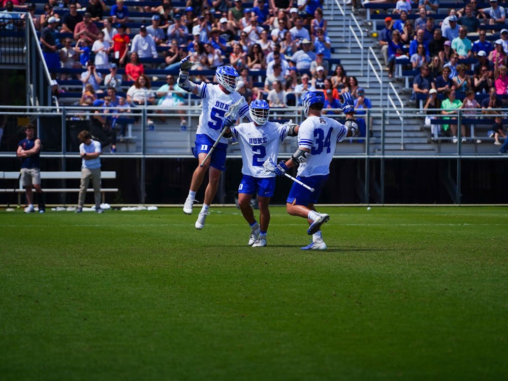 From left: Dyson Williams, Andrew McAdorey and Brennan O'Neill celebrate during Duke's win against Virginia at Koskinen Stadium.