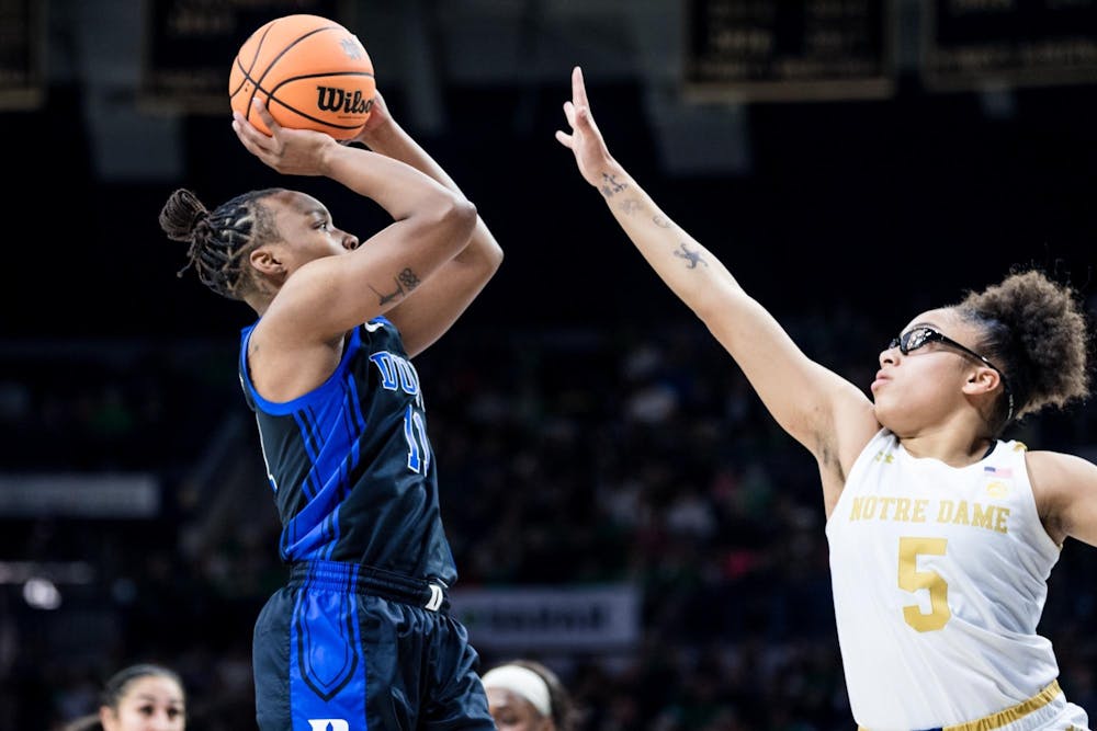 Duke guard Jordyn Oliver rises to shoot over the outstretched hand of Notre Dame star Olivia Miles.