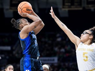 Duke guard Jordyn Oliver rises to shoot over the outstretched hand of Notre Dame star Olivia Miles.
