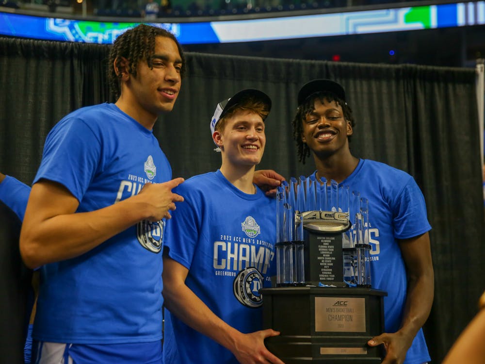 Jaden Schutt (middle) poses for a photo with the ACC tournament trophy.