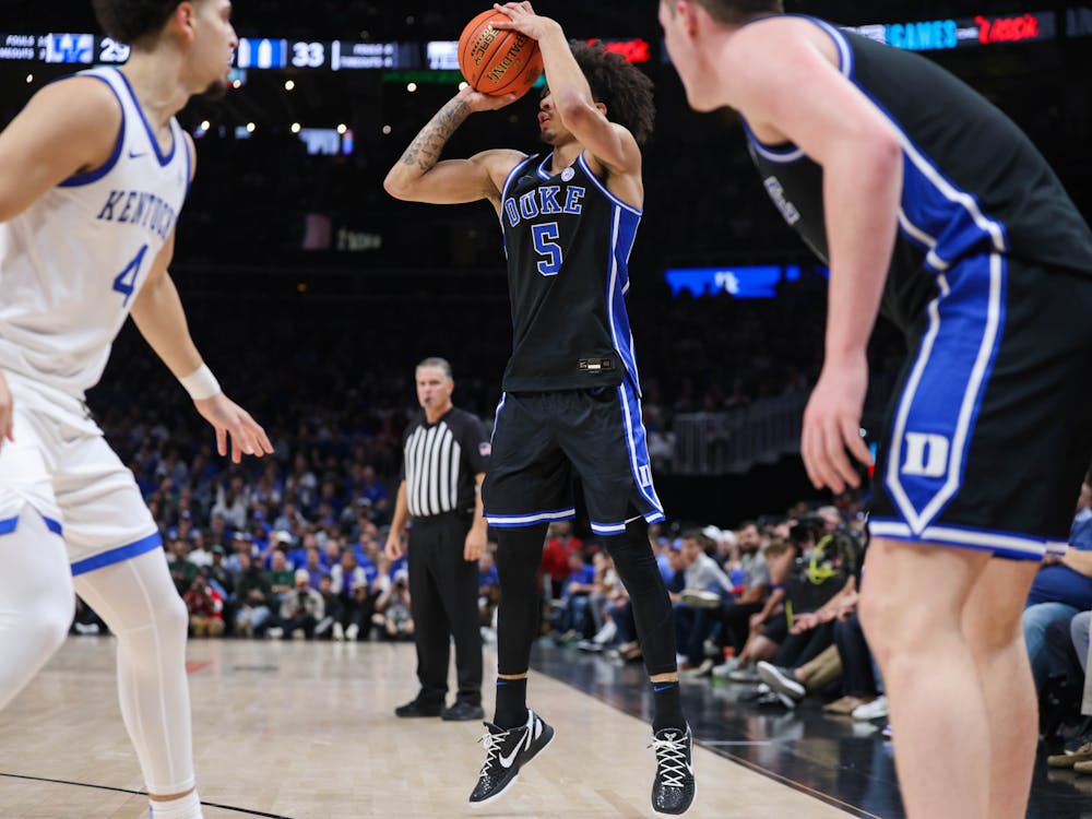 Junior Tyrese Proctor shoots a three in Duke's loss against the Wildcats.