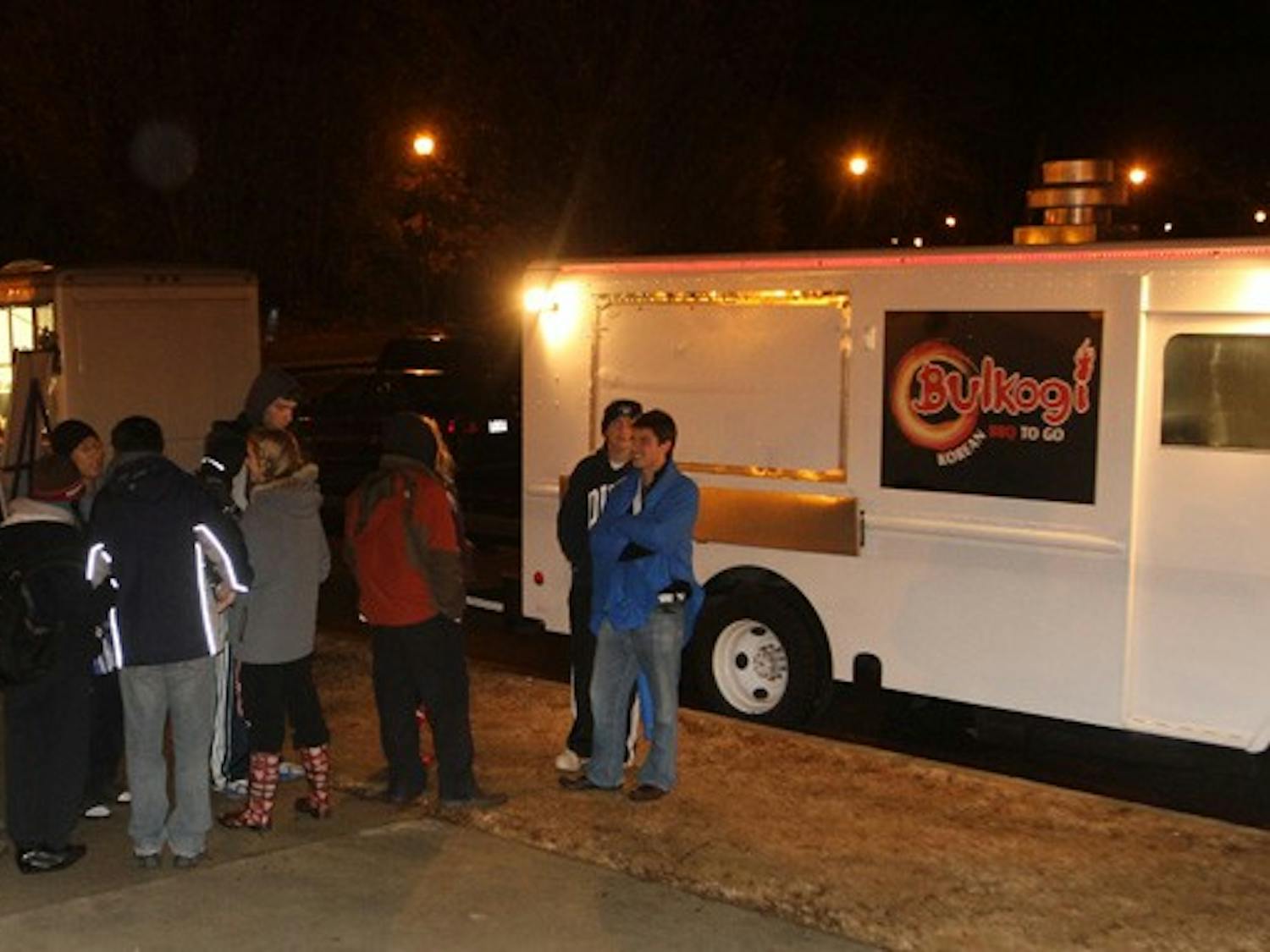 Bulkogi Korean BBQ truck and Parlez-Vous Crepe truck park in the Card Lot at midnight to serve hungry tenters in K-ville.