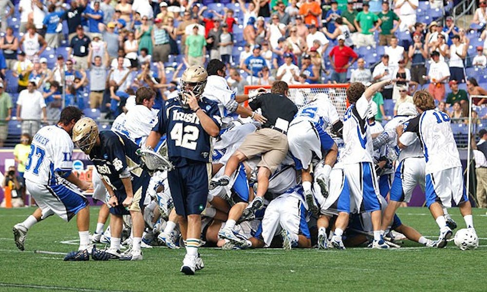Duke players dogpile after beating Notre Dame 6-5 to claim the program's first NCAA title on May 31, 2010.