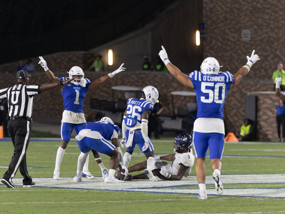 Duke football's defense celebrates after a play against UConn.