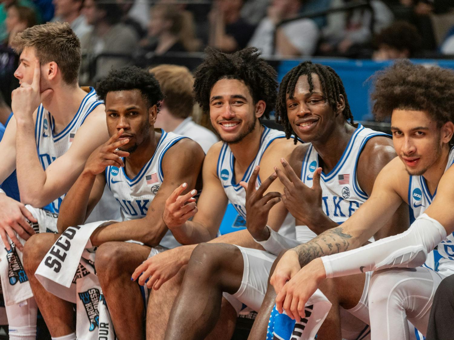Duke's starters smile for the camera as they rest on the bench in the closing minutes of their win against James Madison.