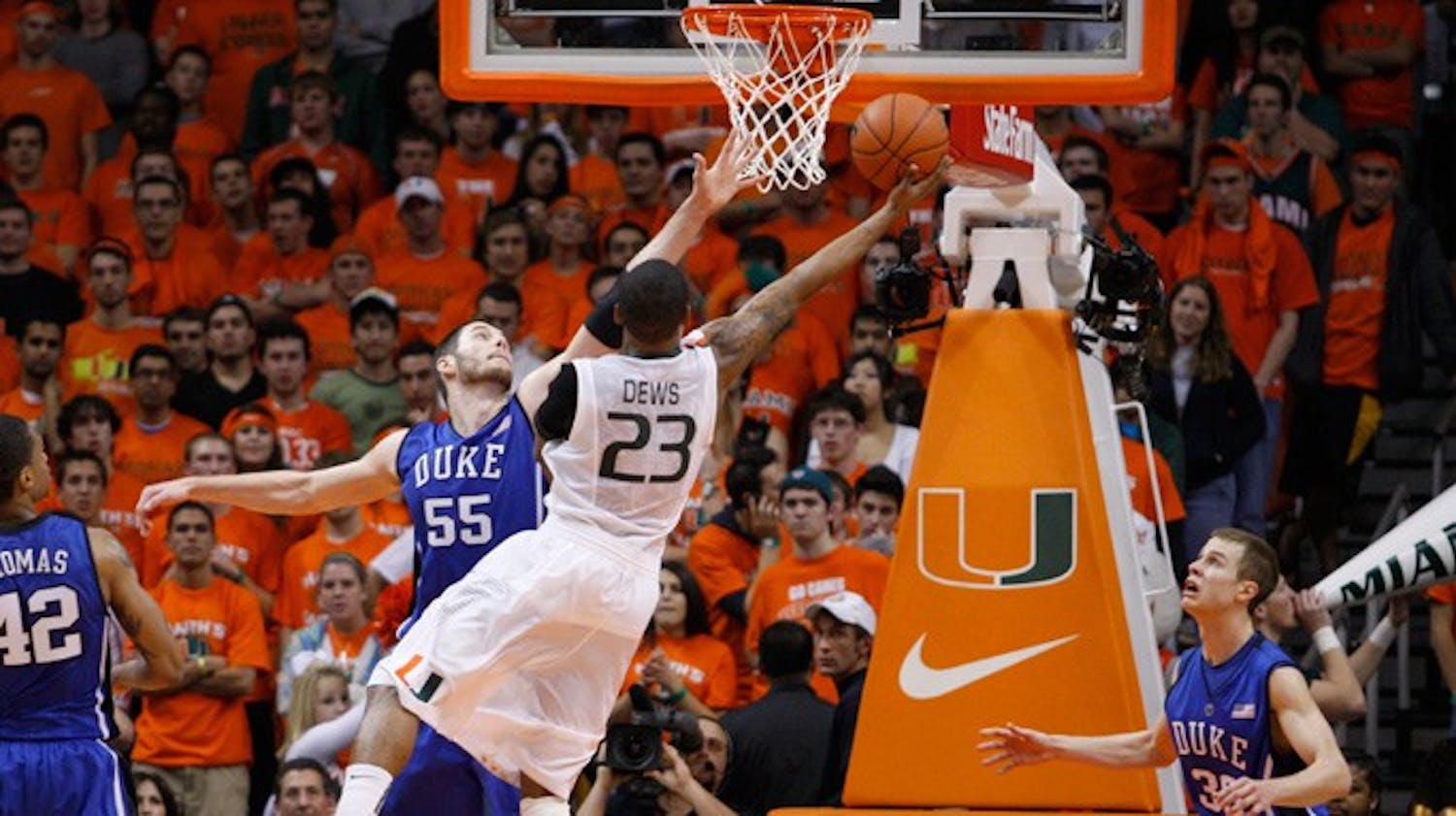 Senior Brian Zoubek goes up for a block against Miami’s driving guard, James Dews, during Duke’s seven-point escape at the BankUnited Center in Coral Gables, Fla.