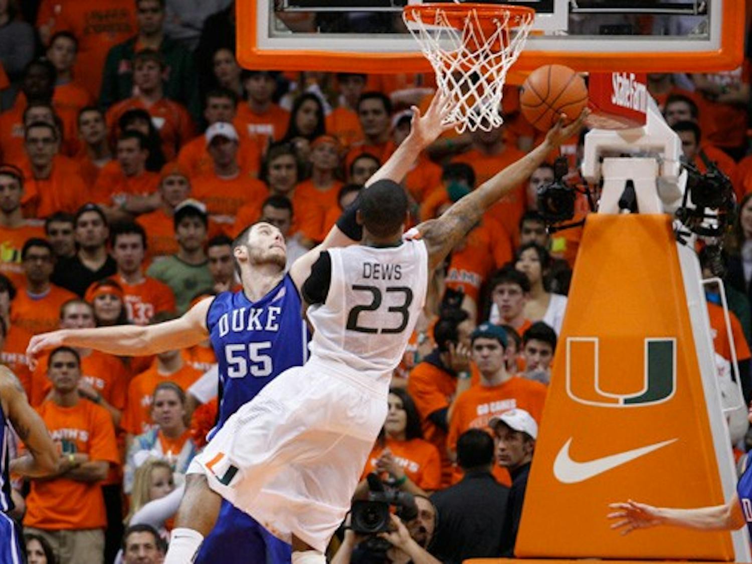 Senior Brian Zoubek goes up for a block against Miami’s driving guard, James Dews, during Duke’s seven-point escape at the BankUnited Center in Coral Gables, Fla.