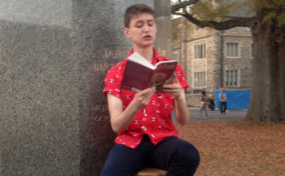 Senior Robbie Florian sits on the Chapel Quad every day at 4 p.m. and reads from the Harry Potter series.