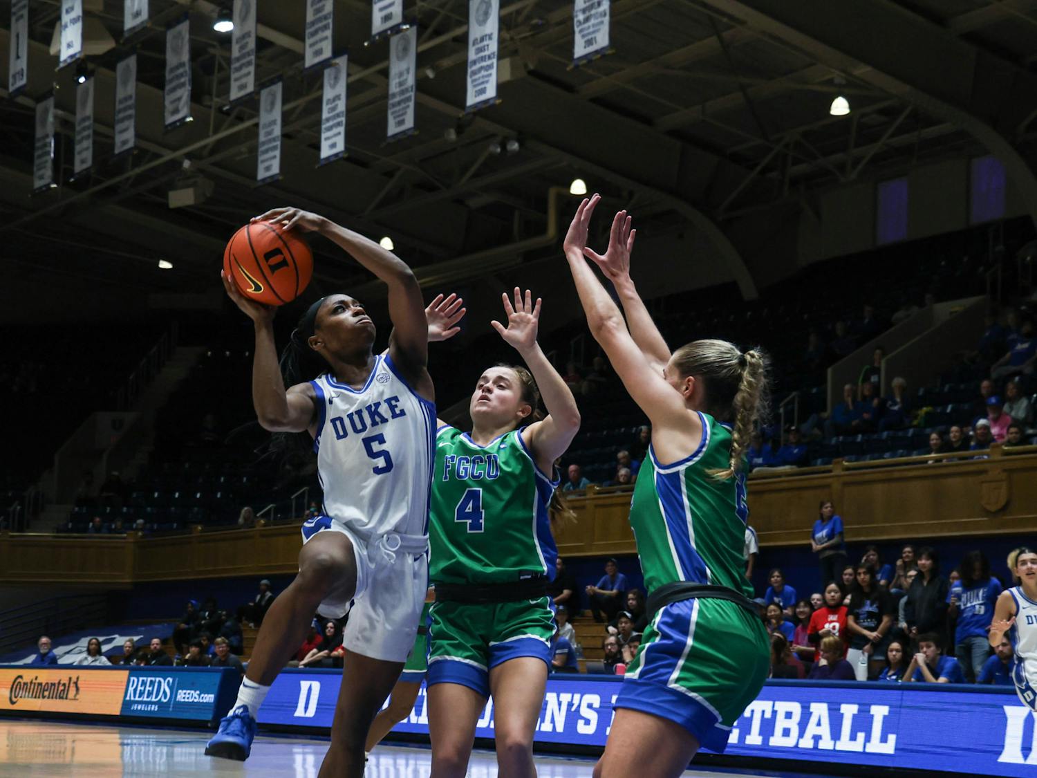 Oluchi Okananwa fights for a shot under double coverage against Florida Gulf Coast.