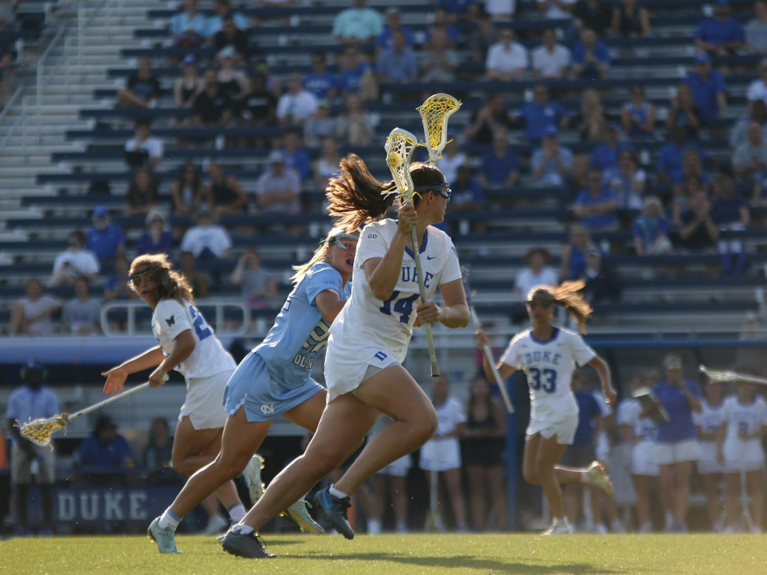 Graduate attacker Maddie Jenner cradles the ball in Duke's regular-season finale against North Carolina.