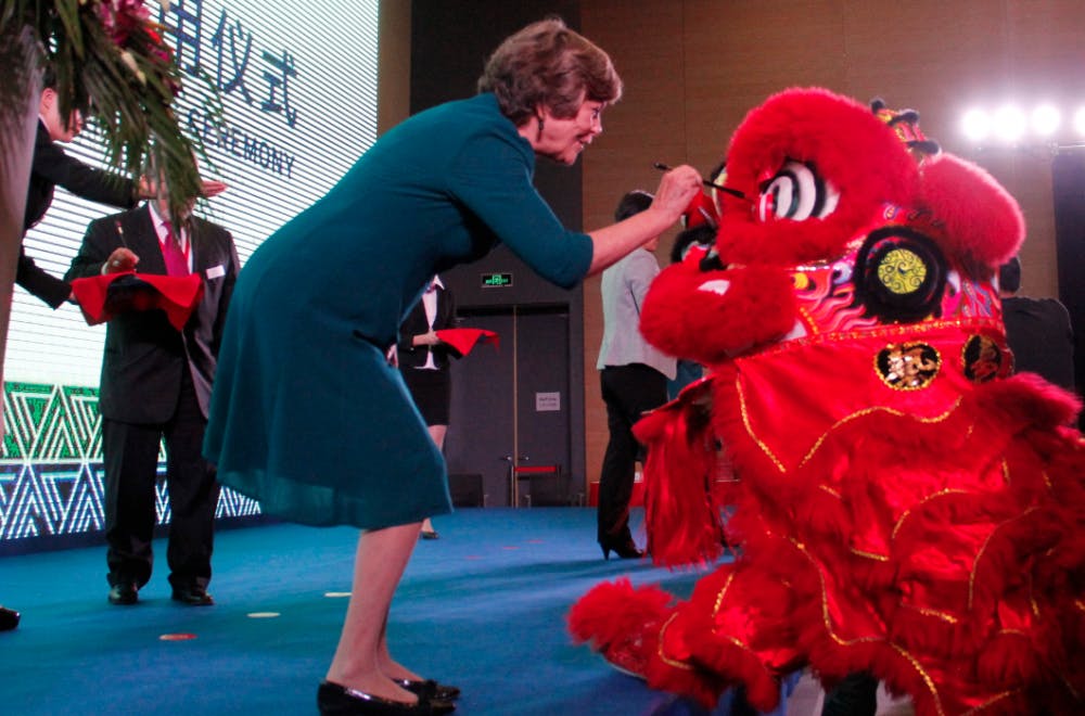Mary Brown Bullock, executive vice chancellor of DKU, paints a ceremonial lion's eyes at the Kunshan campus's grand opening ceremony in November.