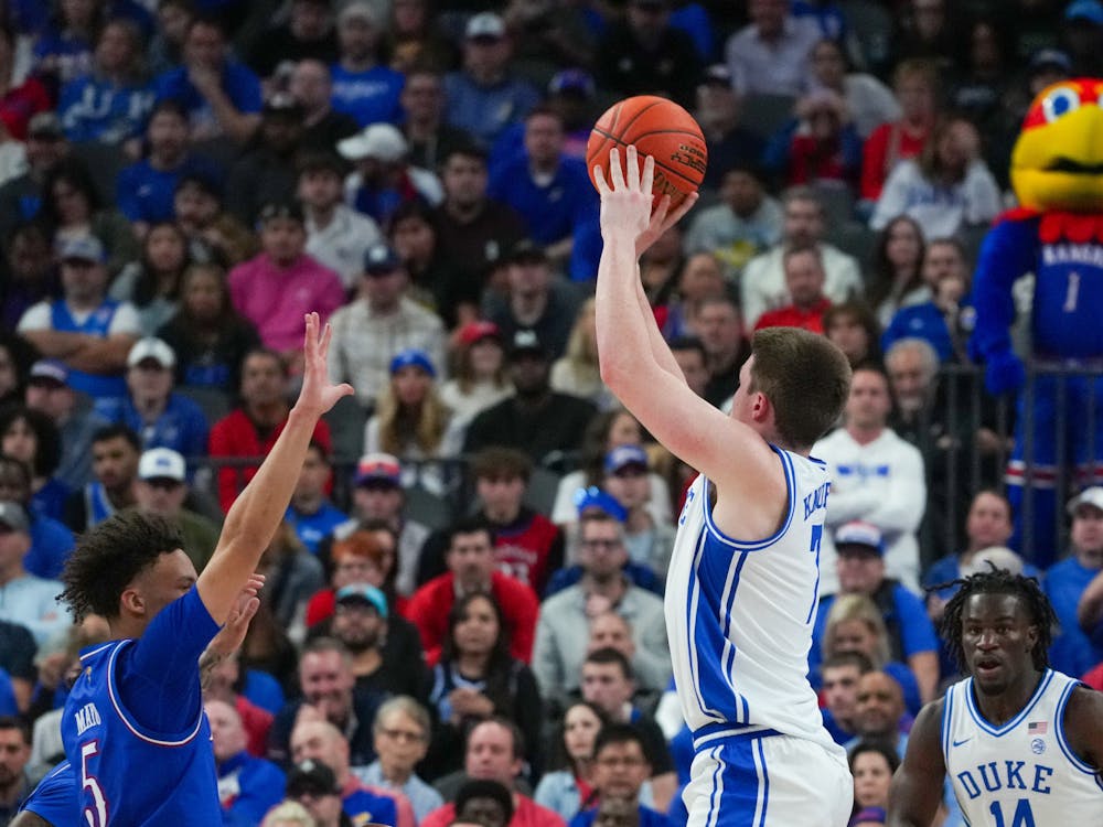 Kon Knueppel shoots over the top of Zeke Mayo. 