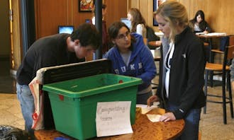 Freshmen partcipating in the annual Eco-Olympics learn how to compost leftover food at the Marketplace Monday afternoon. The competition aims to promote sustainable living among East Campus residents.