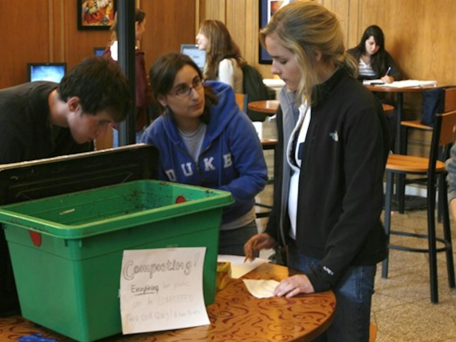 Freshmen partcipating in the annual Eco-Olympics learn how to compost leftover food at the Marketplace Monday afternoon. The competition aims to promote sustainable living among East Campus residents.