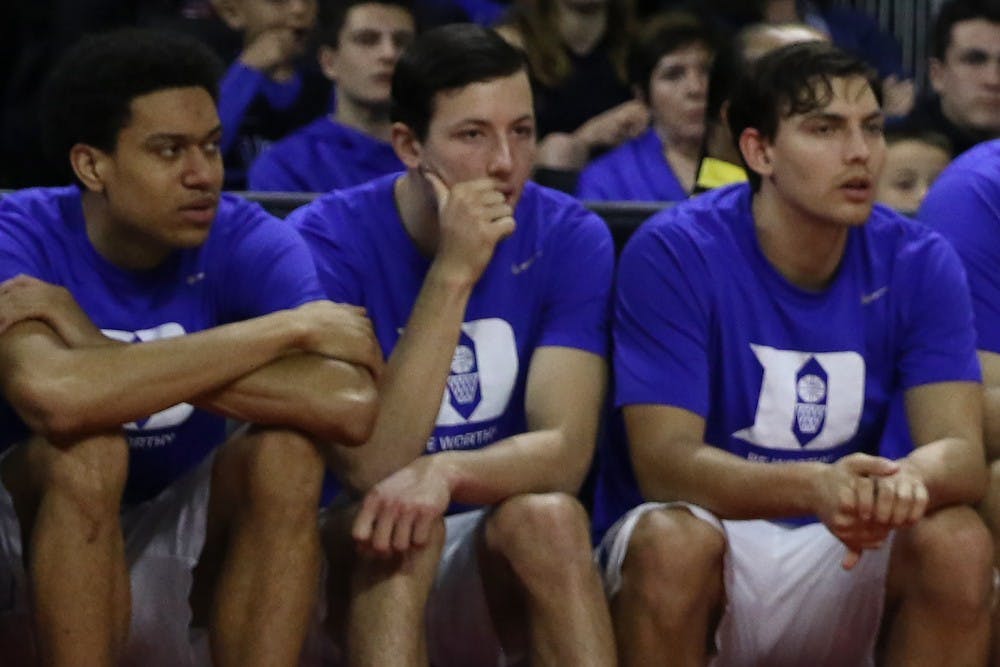 <p>Freshman walk-on Brennan Besser (center) considered playing at Yale but could not pass up the opportunity to be a Blue Devil, even if it meant a smaller role.</p>