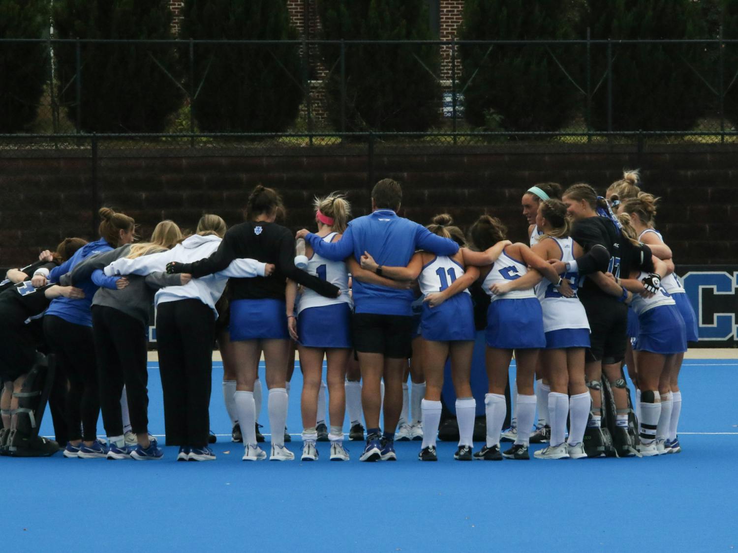Duke field hockey huddles up after its 2022 loss to UNC.