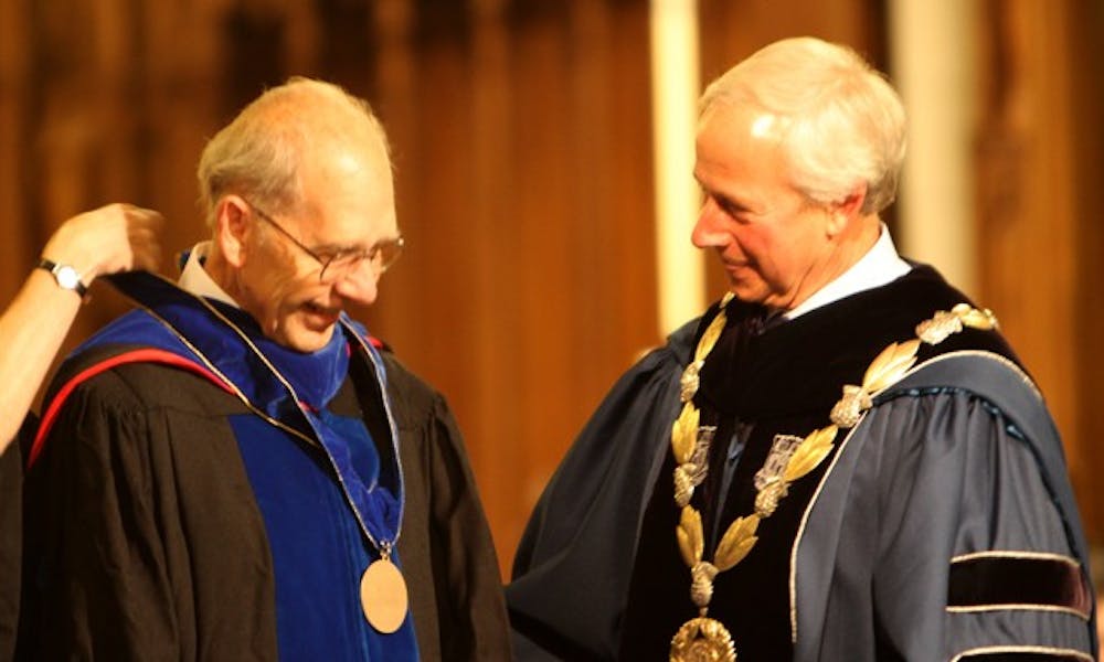 Professor of Chemistry James Bonk receives the second University Medalist from President Richard Broadhead.