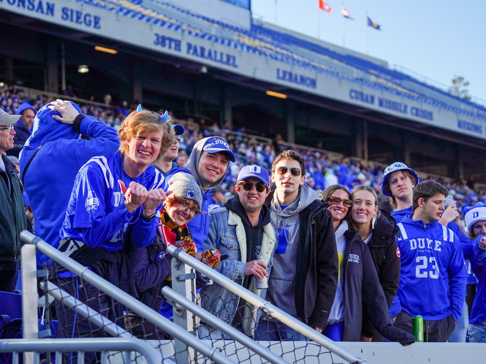 A contingent of Duke students looks on from the crowd at Navy-Marine Corps Memorial Stadium.