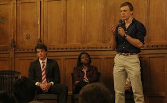 Chris Brown, Alexandra Swain and Strat Waldt take part in a debate in the Great Hall Wednesday.