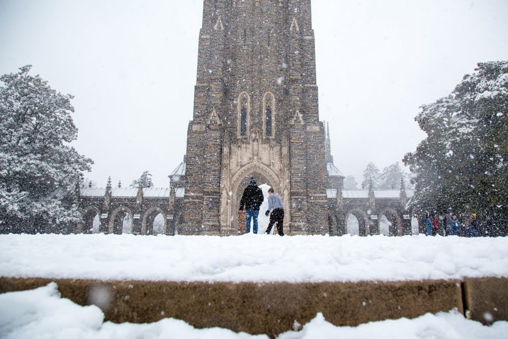 Sophomores Josh Young and Ameen Ahmad build a snowman in front of the chapel. Photo by Charles York