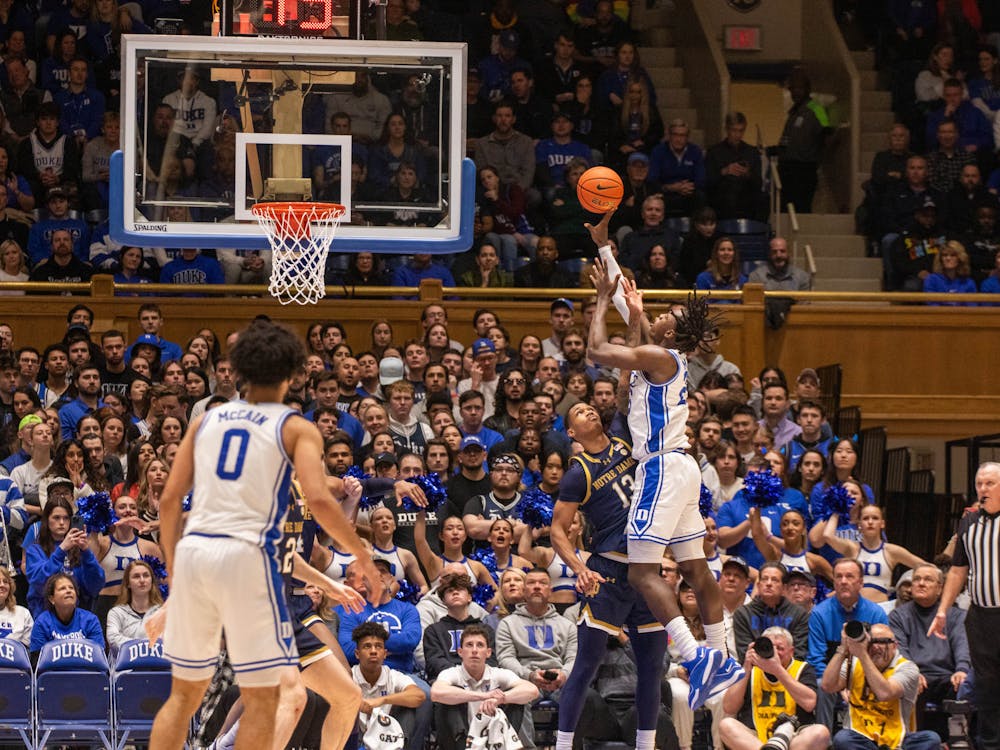 Mark Mitchell lifts a shot over a Notre Dame defender during the first half of Duke's Wednesday night victory.