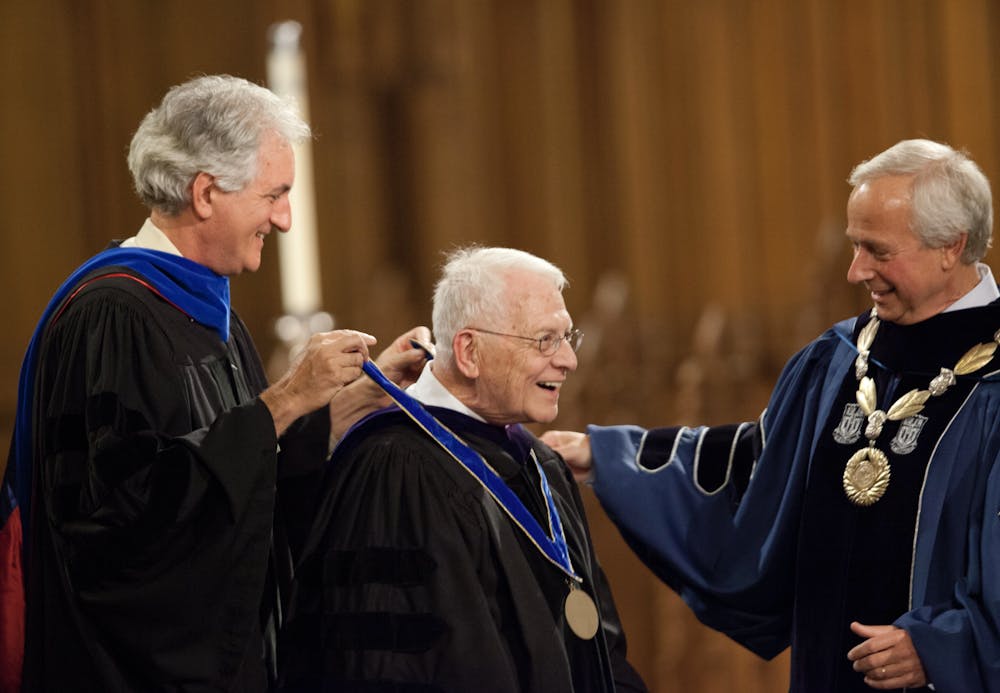 <p>Gerald Wilson (middle) received the University Medal, Duke's highest honor, from Academic Council Chair Josh Socolar (left) and President Richard Brodhead (right) in 2013.</p>