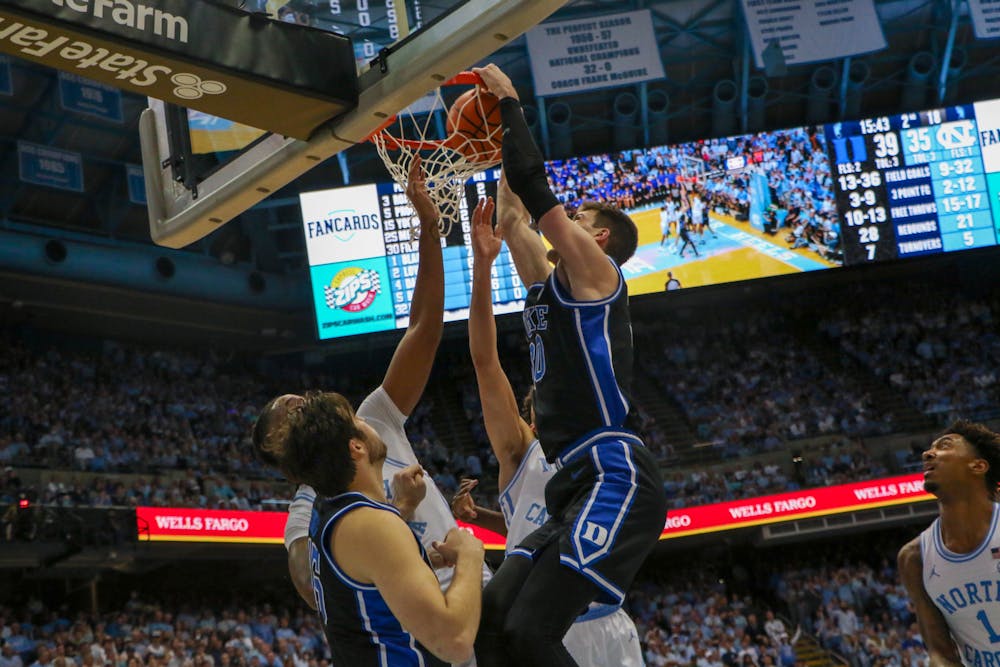 Kyle Filipowski dunks on a North Carolina defender during Duke's March 4 win in Chapel Hill.