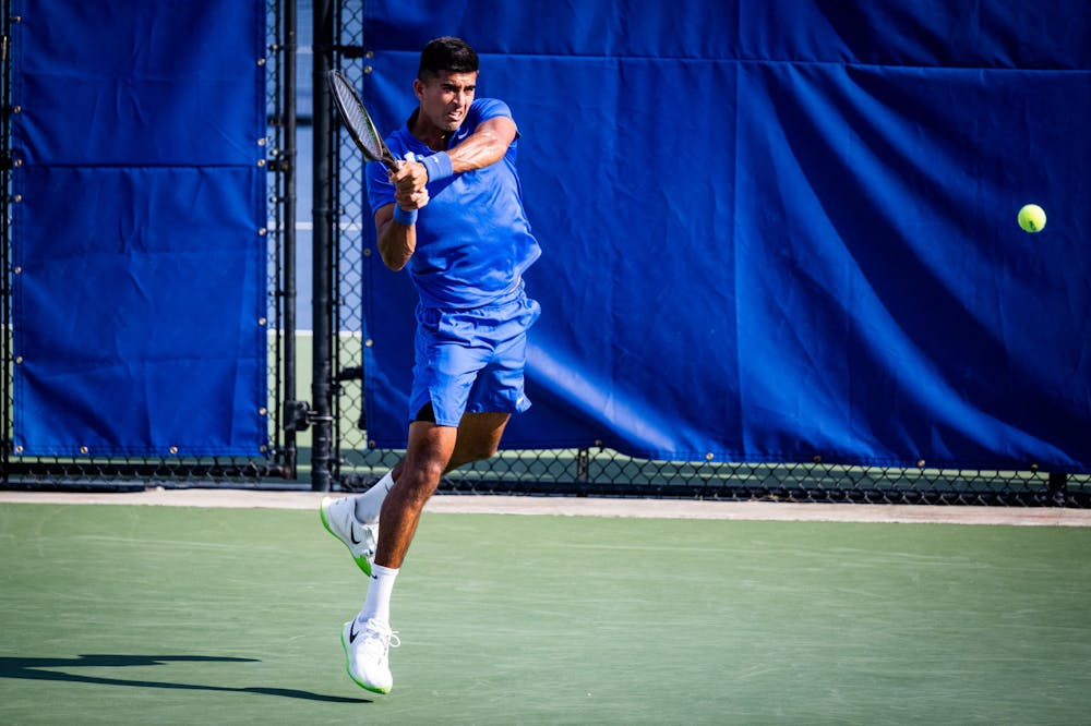 Faris Khan hits a backhand in the NCAA tournament. 