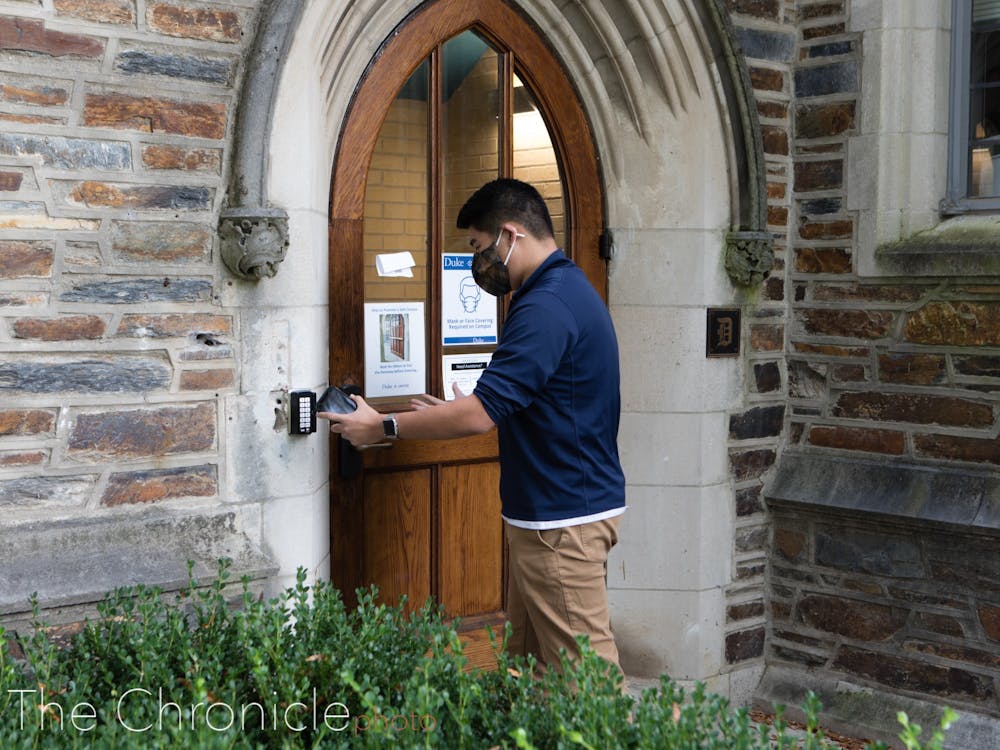 <p>A student swipes in to a West Campus dorm.</p>