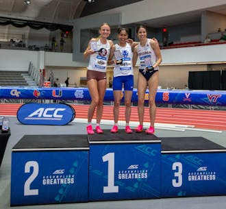 Amina Maatoug stands atop the podium after winning the mile at the ACC Indoor Championships. 