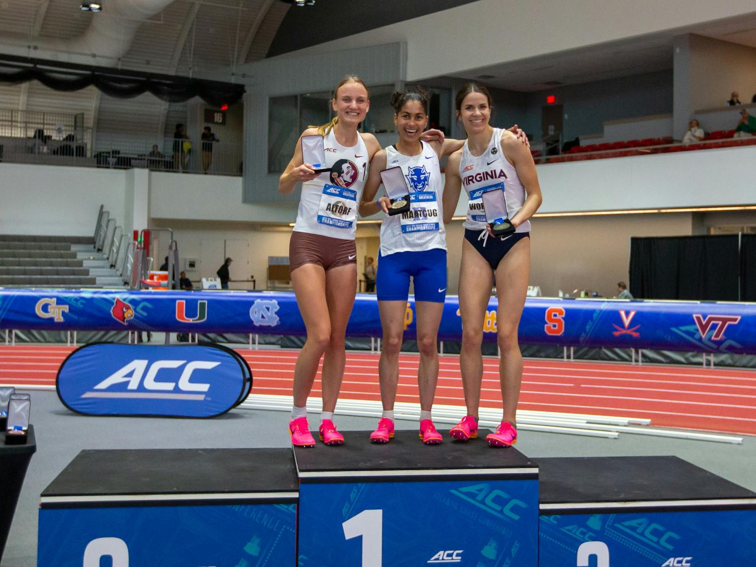 Amina Maatoug stands atop the podium after winning the mile at the ACC Indoor Championships. 