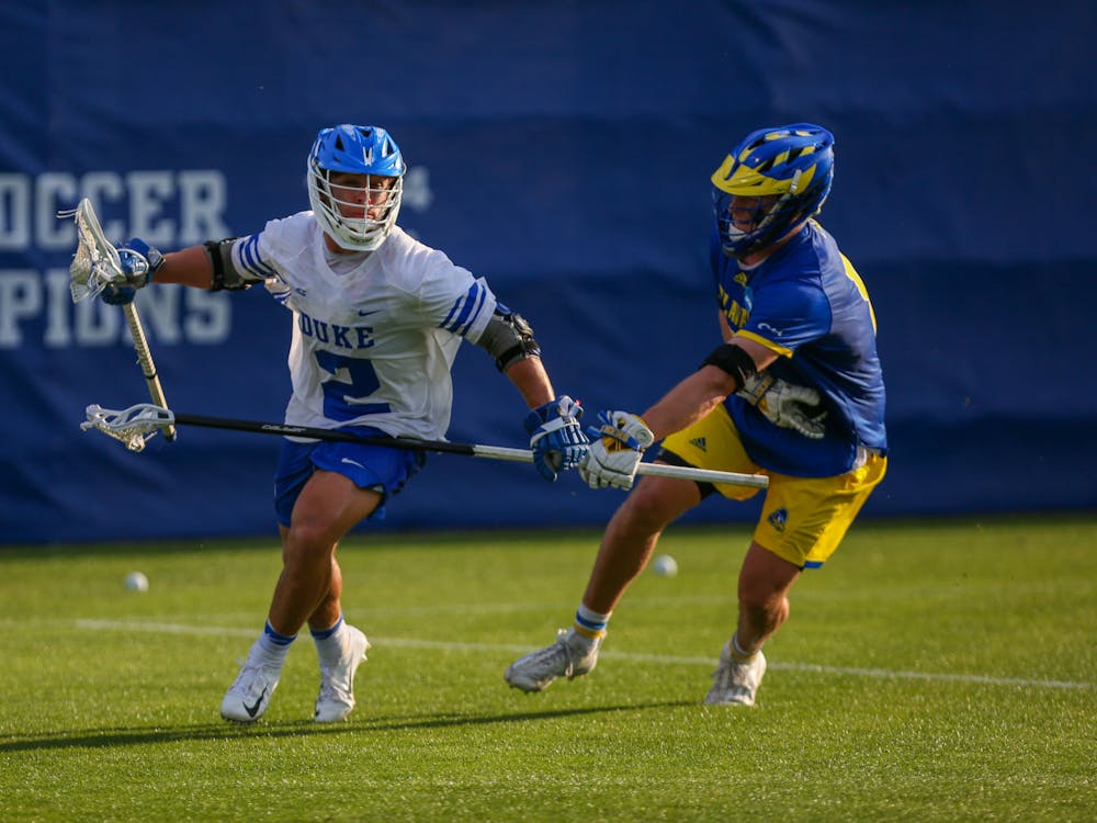 Sophomore attackman Andrew McAdorey rushes around the crease in Duke's Sunday triumph against Delaware.