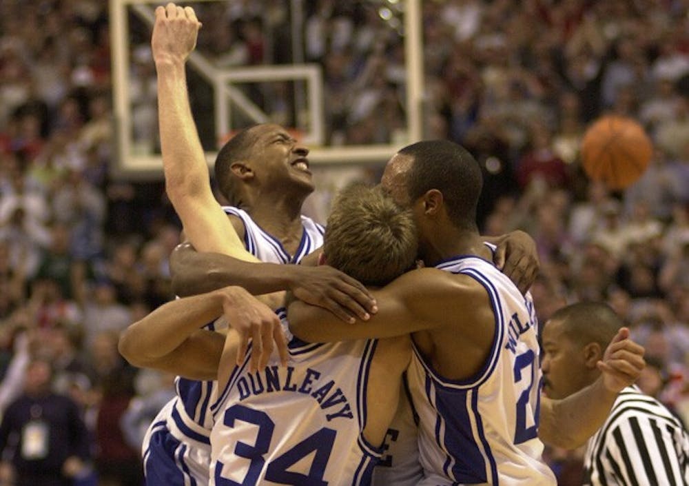 Chris Duhon, Mike Dunleavy, Jay Williams and one unidentified player celebrate after Duke’s victory in the 2001 national championship game.