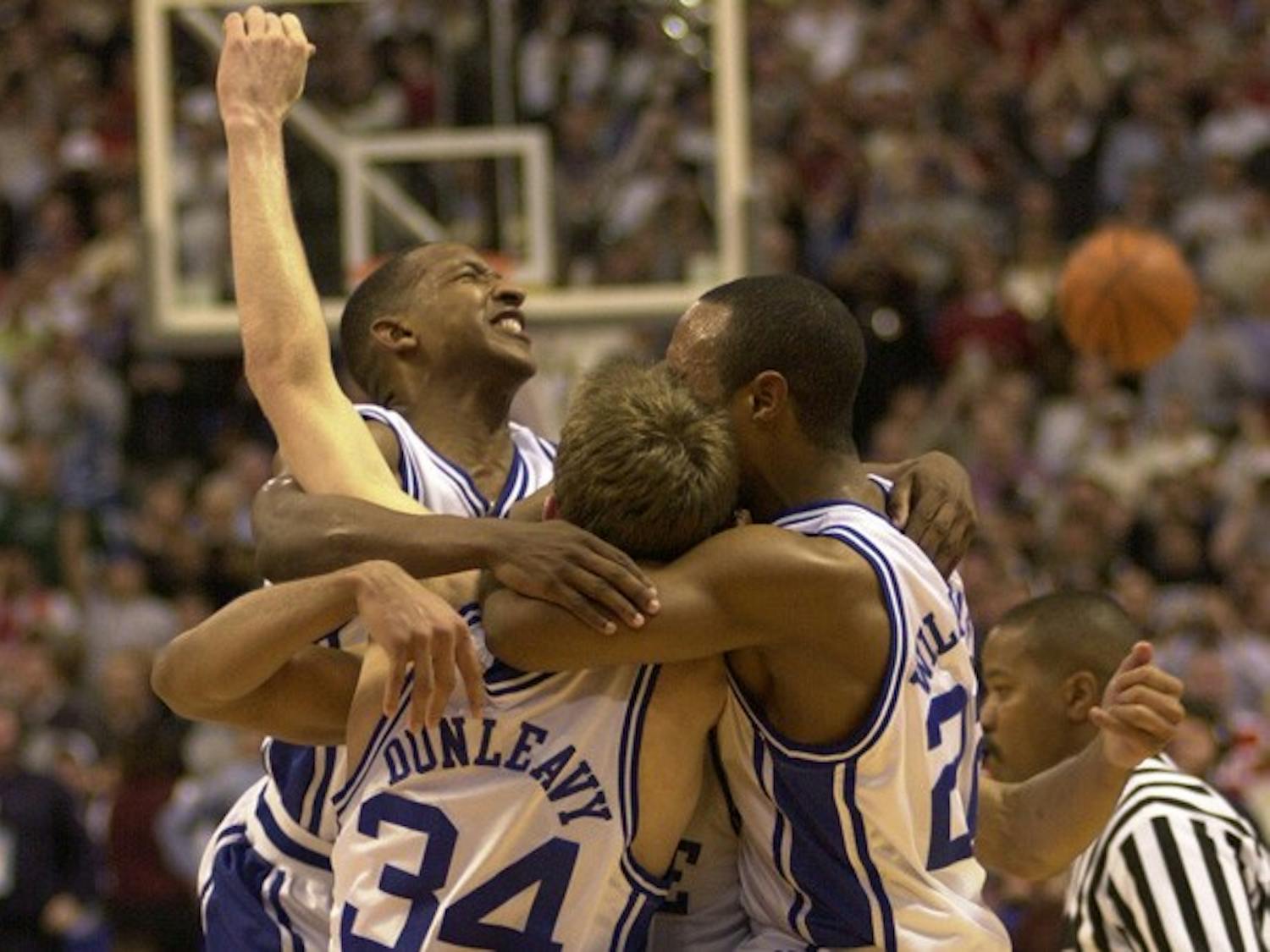 Chris Duhon, Mike Dunleavy, Jay Williams and one unidentified player celebrate after Duke’s victory in the 2001 national championship game.