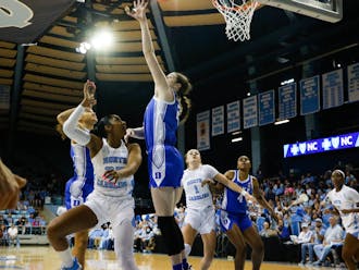 Junior center Kennedy Brown reaches for the block during Duke's narrow loss at North Carolina.
