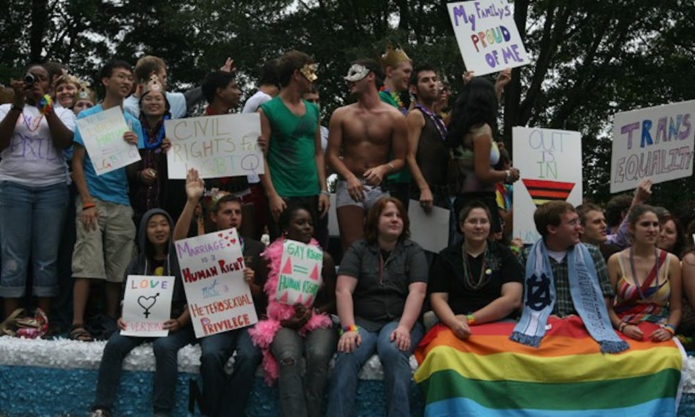 Students ride along in the 25th annual North Carolina Pride Festival and Parade off East Campus Saturday.
