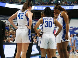 Duke players huddle during their ACC tournament quarterfinal win against North Carolina.