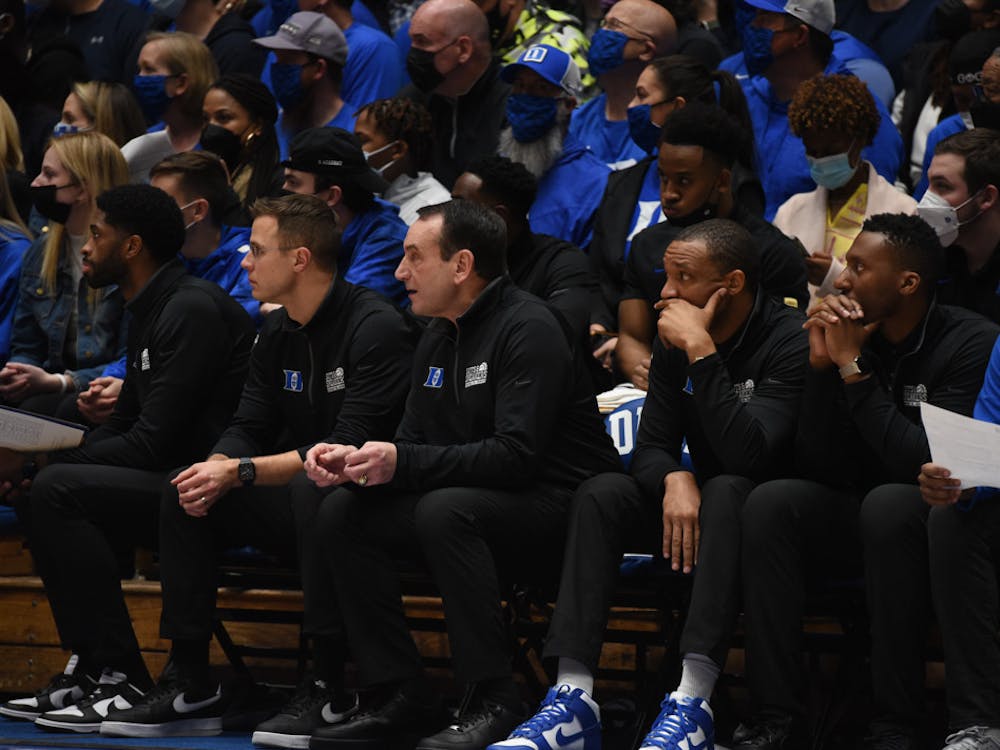 <p>Head coach Mike Krzyzewski and his assistant coaches watch a recent game in Cameron Indoor Stadium.</p>
