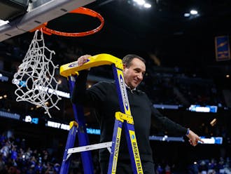 Former Duke head coach Mike Krzyzewski cuts the nets after the final win of his career — against Arkansas in the 2021-22 Elite Eight.