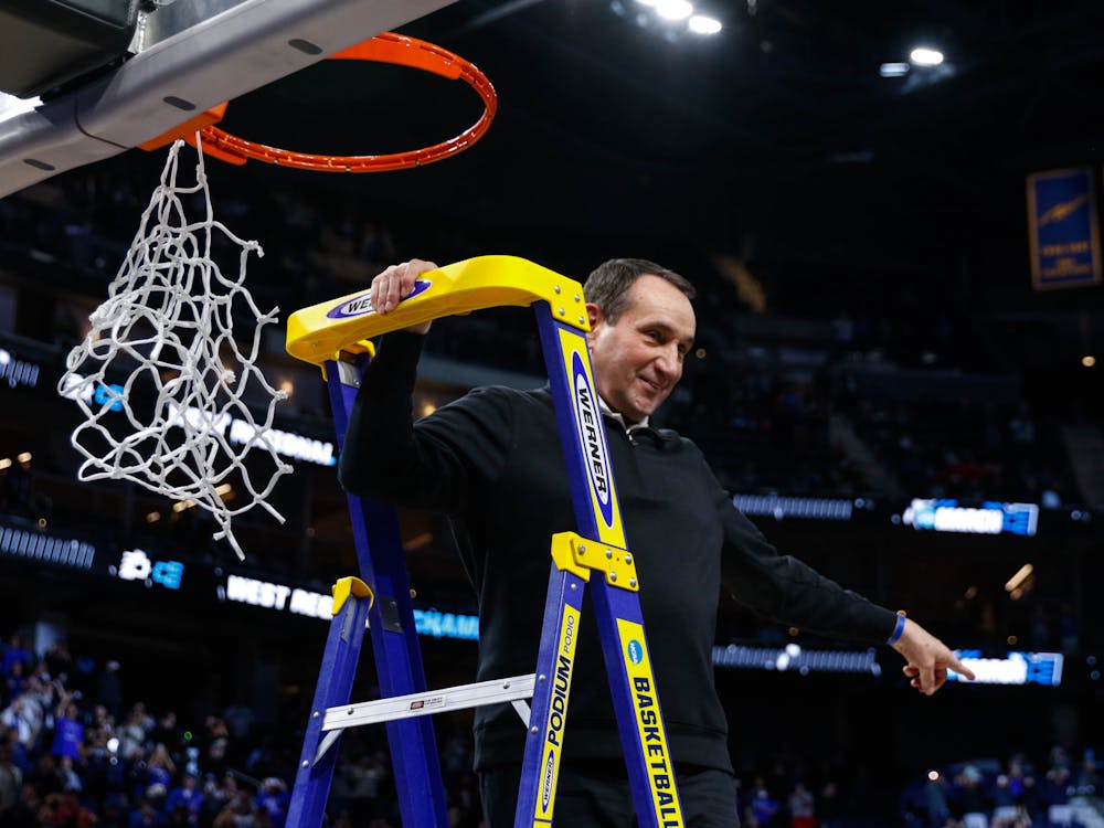Former Duke head coach Mike Krzyzewski cuts the nets after the final win of his career — against Arkansas in the 2021-22 Elite Eight.