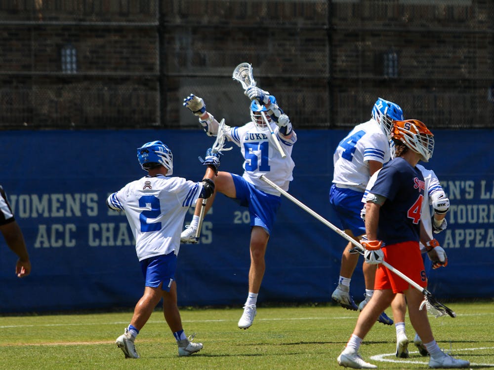 Andrew McAdorey (2) and Dyson Williams (51) celebrate in Duke's 18-15 win against Syracuse.