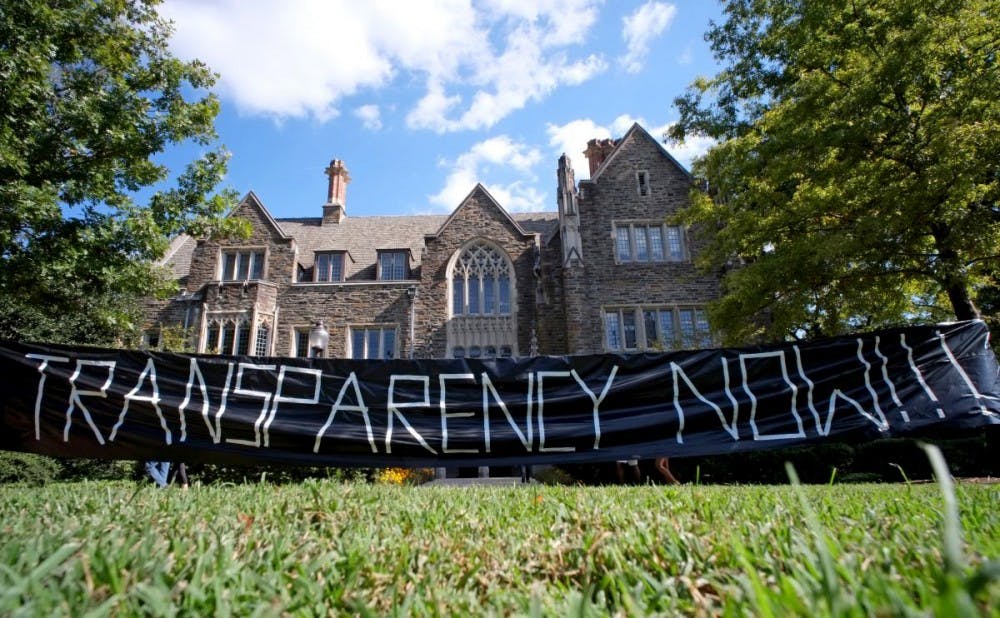 <p>DukeOpen members continued their push for endowment transparency by hanging the sign above in front of the Allen Building in October 2013.</p>