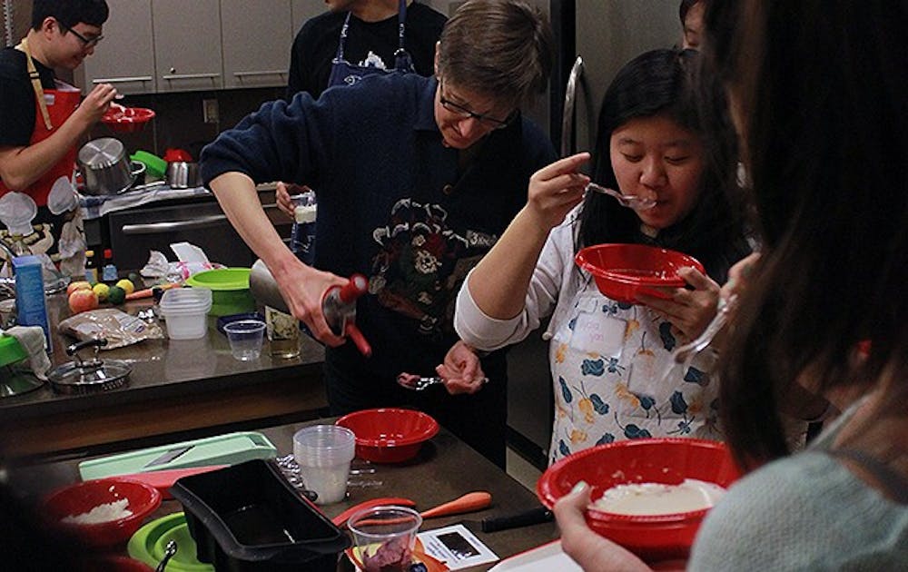 A freshman seminar taught by a chemistry professor and a professional chef applies basic principles of chemistry to cooking techniques. Students here experiment with making cheese.