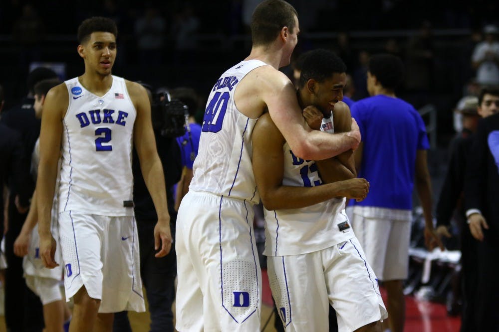 Marshall Plumlee and Matt Jones celebrate after advancing to the Sweet 16 for the second straight year.