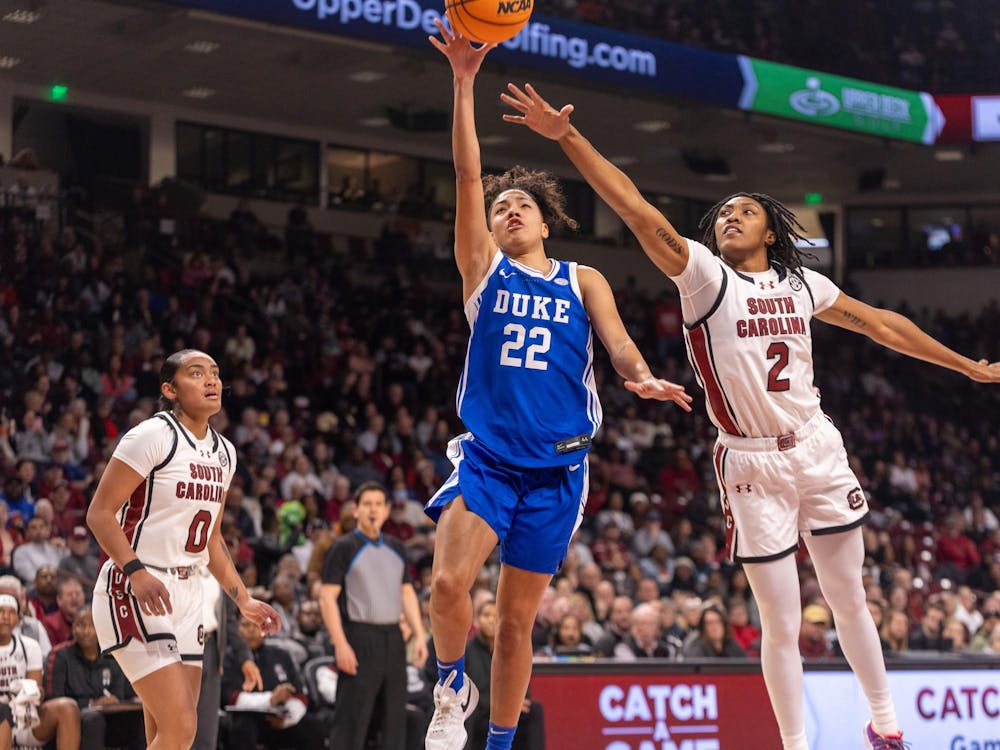 Taina Mair goes up for the finish over South Carolina's Ashlyn Watkins. 